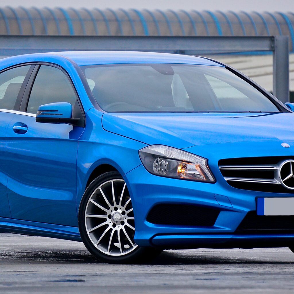 Blue Mercedes-Benz A-Class hatchback on concrete.